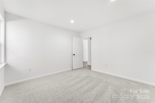 unfurnished room featuring recessed lighting, light carpet, and baseboards