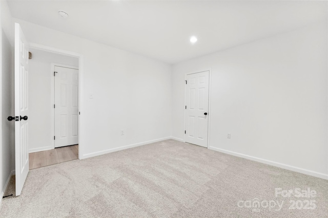 unfurnished room featuring recessed lighting, carpet, and baseboards