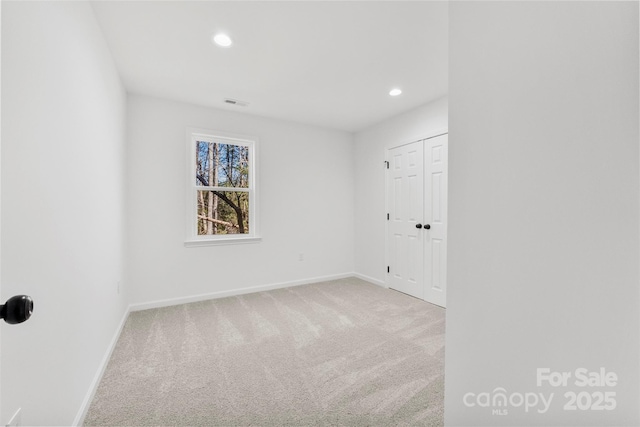 unfurnished room with recessed lighting, carpet, and baseboards