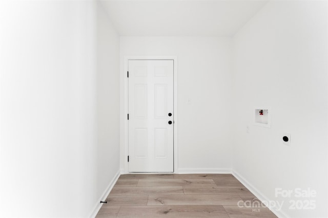 clothes washing area featuring washer hookup, light wood finished floors, hookup for an electric dryer, laundry area, and baseboards