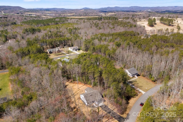 bird's eye view featuring a mountain view and a view of trees