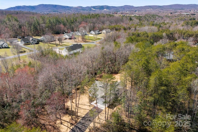 bird's eye view with a forest view and a mountain view