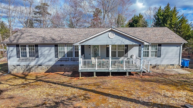 ranch-style home with a porch, crawl space, roof with shingles, and a front lawn