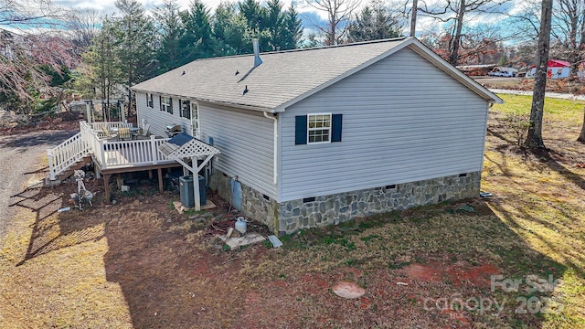 rear view of property featuring a shingled roof, stairway, crawl space, cooling unit, and a wooden deck