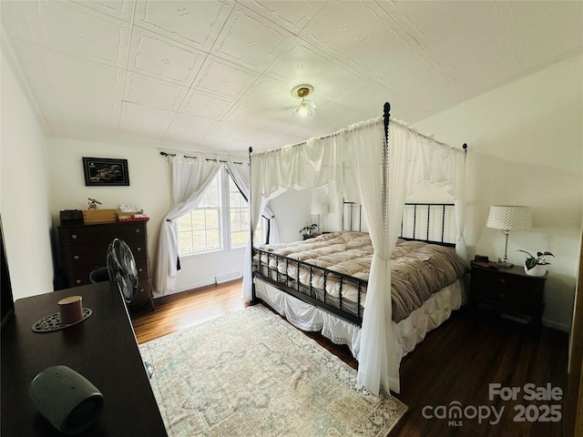 bedroom featuring an ornate ceiling and wood finished floors