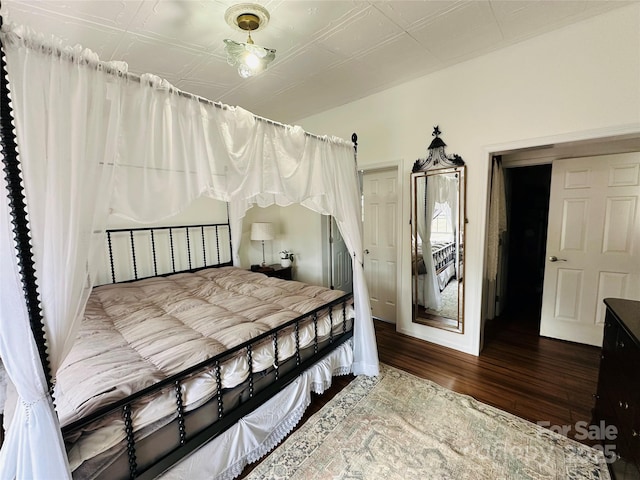 bedroom with an ornate ceiling and wood finished floors