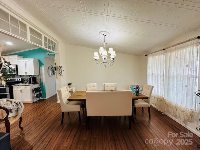 dining space featuring dark wood-style floors and a chandelier