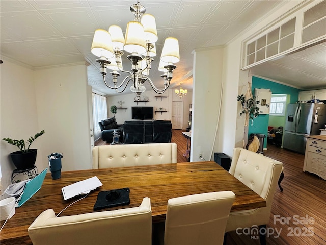 dining area with wood finished floors, an ornate ceiling, and a notable chandelier