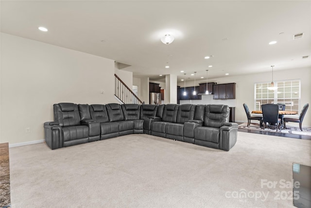 living area featuring visible vents, baseboards, stairs, light carpet, and recessed lighting