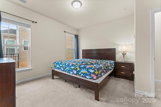 bedroom featuring multiple windows, carpet flooring, and baseboards