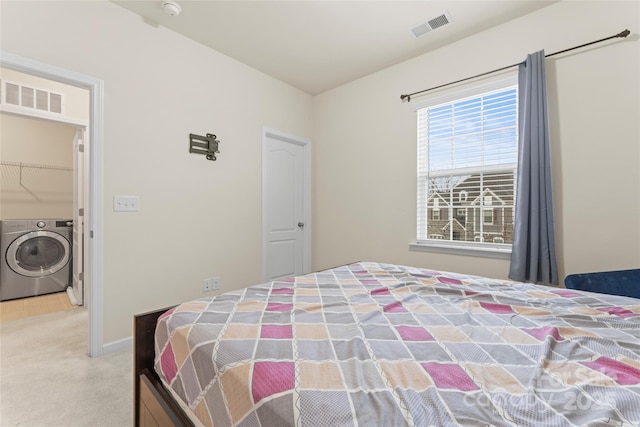 bedroom featuring washer / clothes dryer, carpet, visible vents, and baseboards