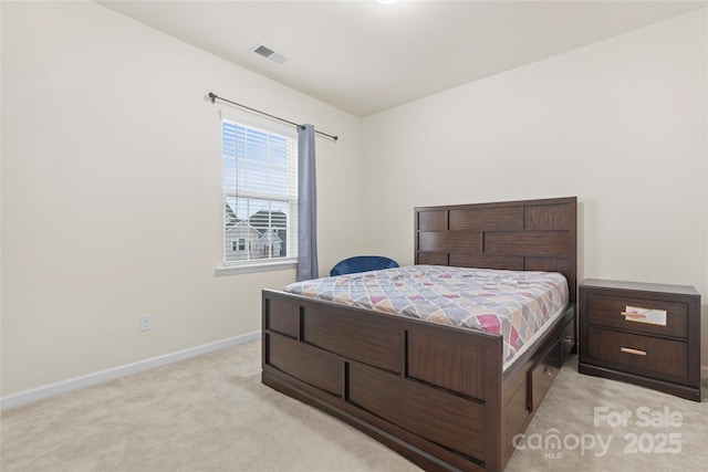 bedroom featuring visible vents, light colored carpet, and baseboards