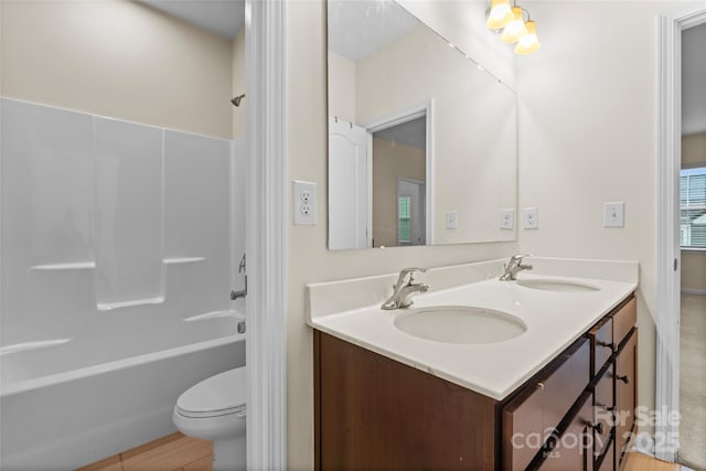 full bath with a sink, bathing tub / shower combination, toilet, and double vanity