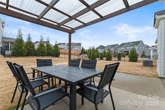 view of patio with a residential view, central AC, outdoor dining area, a fenced backyard, and a pergola