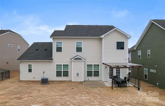 back of property with a patio, fence, central AC, and a shingled roof