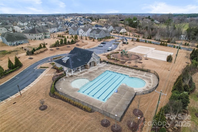 view of swimming pool with a residential view and a hot tub