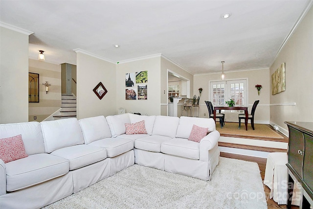 living room featuring stairs, baseboards, crown molding, and recessed lighting