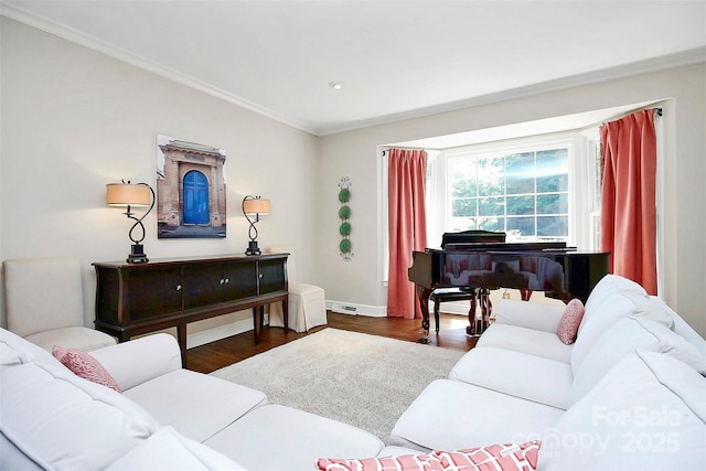 living area with crown molding, baseboards, and wood finished floors