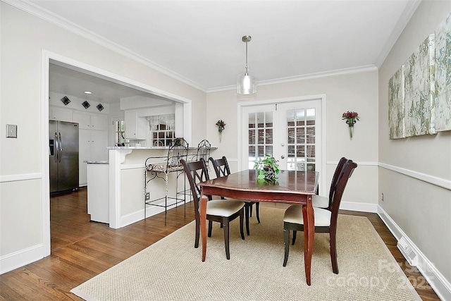 dining area featuring visible vents, baseboards, french doors, dark wood finished floors, and crown molding