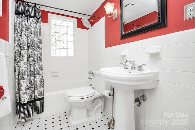 full bathroom featuring visible vents, wainscoting, toilet, shower / bath combination with curtain, and tile walls