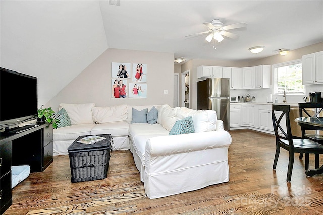 living area with dark wood finished floors and a ceiling fan