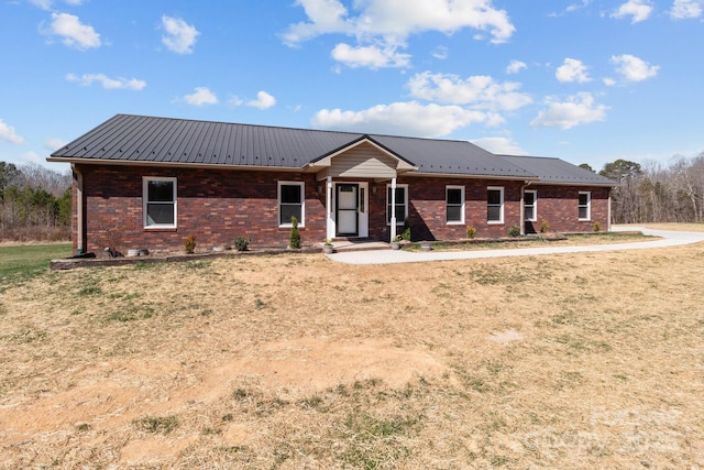 ranch-style house with brick siding and metal roof