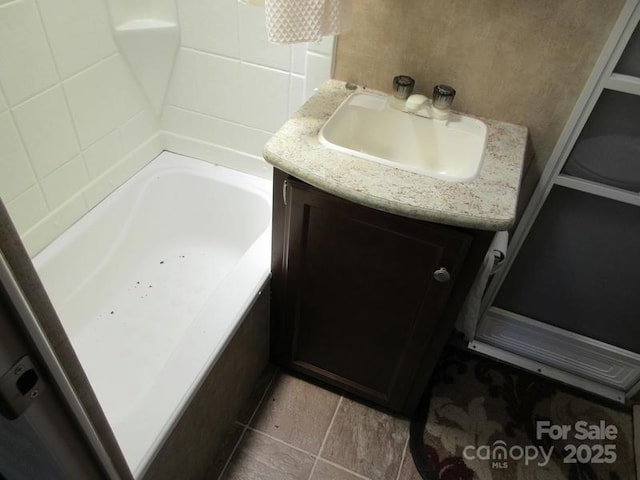 full bathroom with a washtub and vanity