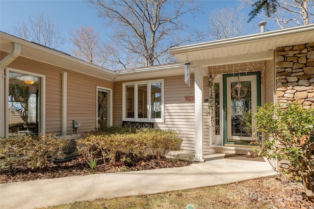 property entrance featuring stone siding