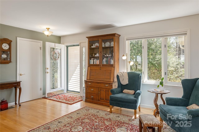 sitting room featuring light wood finished floors and baseboards