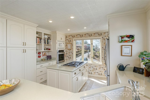 kitchen with wallpapered walls, appliances with stainless steel finishes, light countertops, open shelves, and recessed lighting