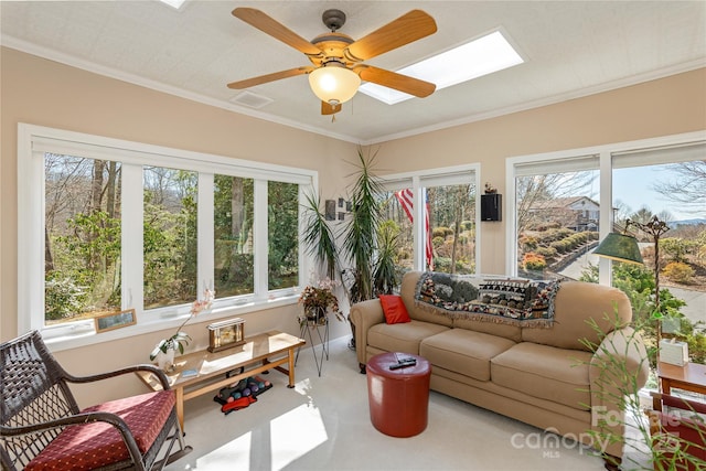 sunroom / solarium with a skylight and a ceiling fan