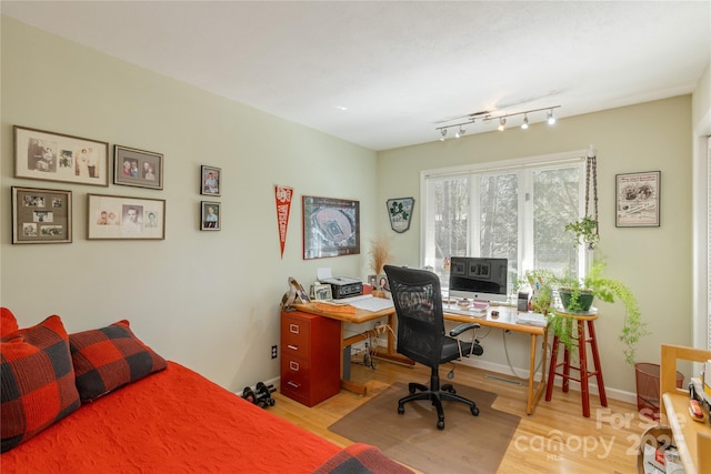 bedroom featuring baseboards and wood finished floors