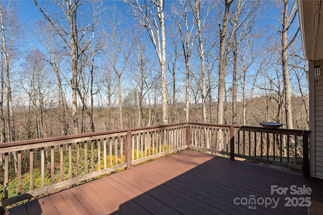 wooden terrace with a view of trees