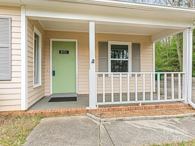 doorway to property featuring covered porch