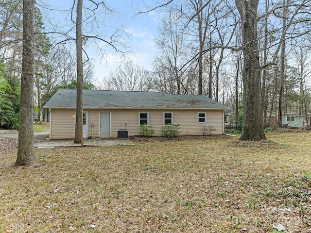 back of house with a patio, a yard, and central air condition unit