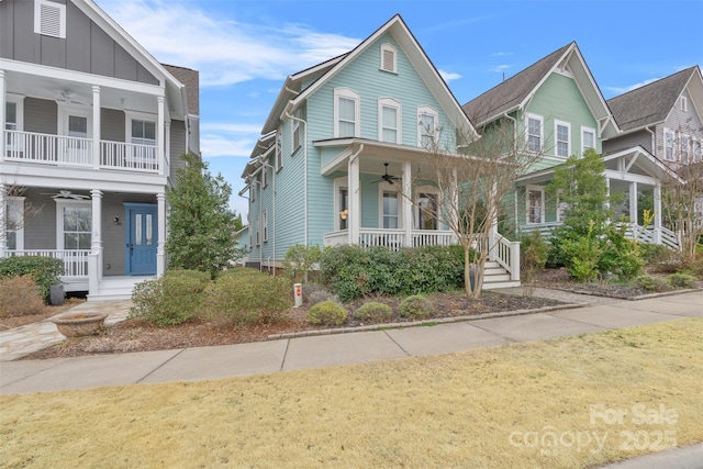 view of front of property with board and batten siding, a ceiling fan, and covered porch