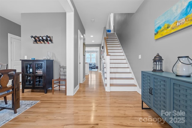 foyer featuring stairway, recessed lighting, baseboards, and light wood-type flooring