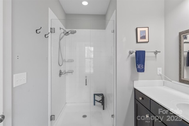 bathroom featuring vanity and a shower stall