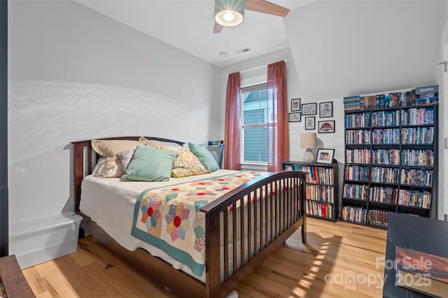 bedroom featuring a ceiling fan, wood finished floors, and visible vents