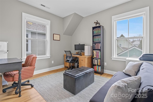 office featuring visible vents, baseboards, and light wood-style floors