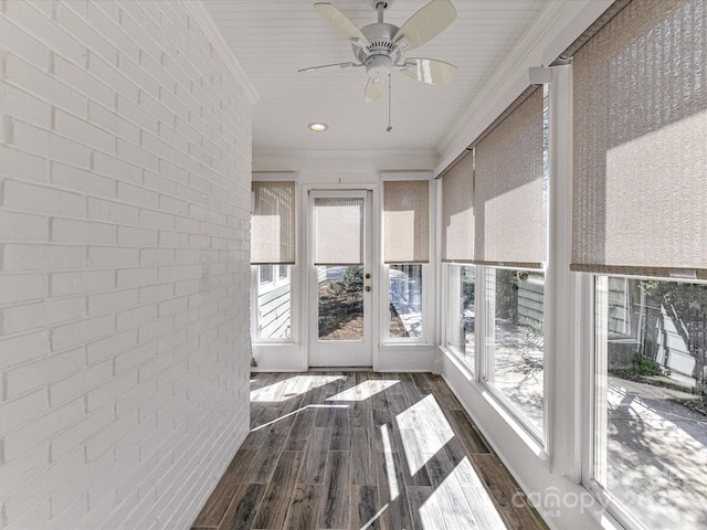 unfurnished sunroom featuring a ceiling fan