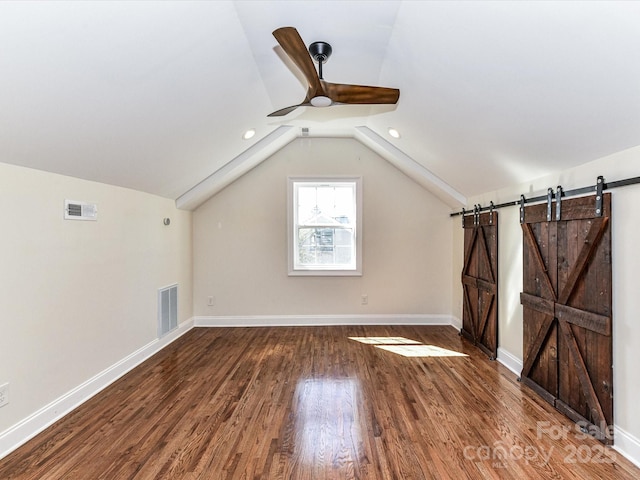 bonus room with visible vents, baseboards, lofted ceiling, and wood finished floors