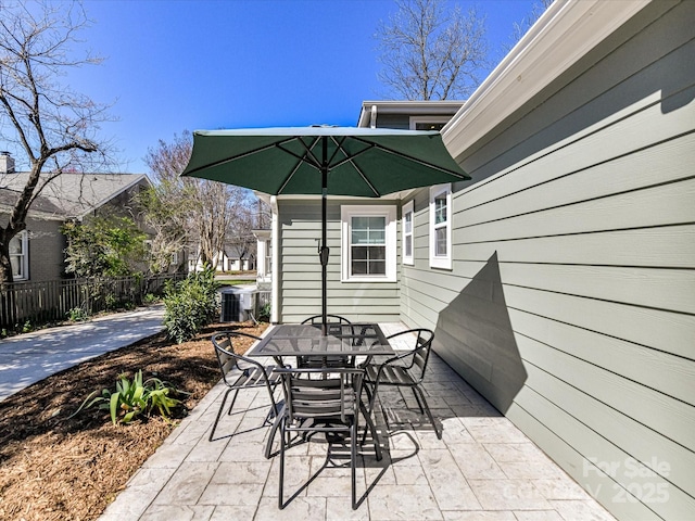 view of patio with outdoor dining space and fence