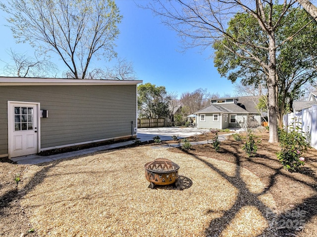 view of yard with an outdoor fire pit and fence