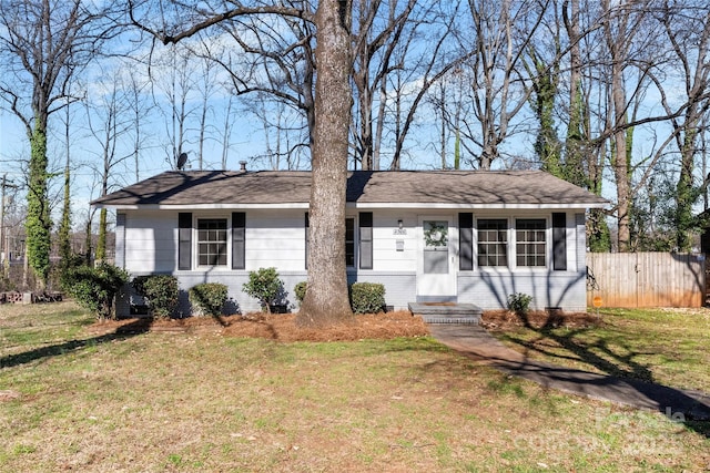 ranch-style house featuring a front yard, brick siding, entry steps, and fence