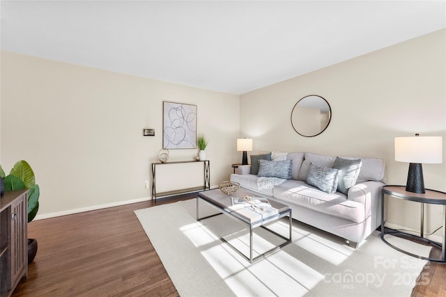 living area featuring wood finished floors and baseboards