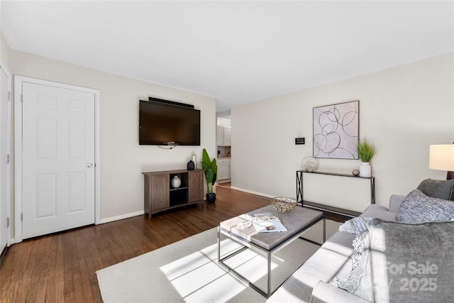 living room with baseboards and wood finished floors