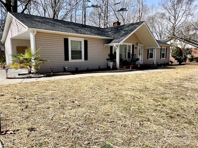 ranch-style home with a chimney and a front lawn