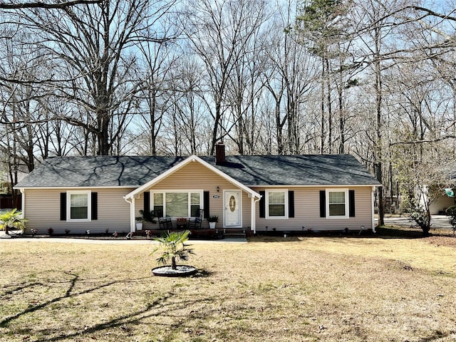 ranch-style house featuring a porch, a chimney, and a front yard