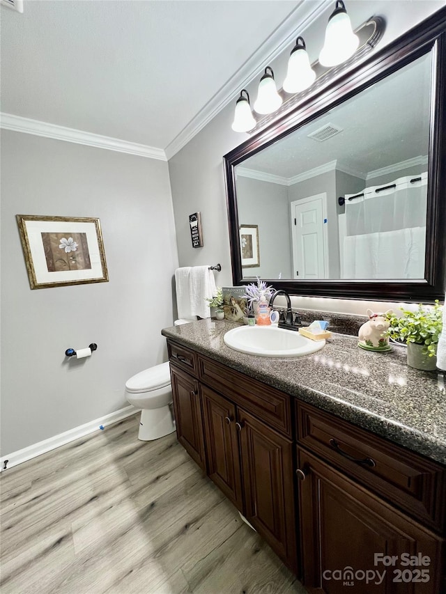 full bathroom with crown molding, visible vents, toilet, vanity, and wood finished floors